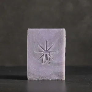 Studio shot of Black Altar Mystic Twilight soap—dusty lavender bar with star-altar logo on dark backdrop