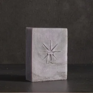 Studio shot of Black Altar Mystic Twilight soap—dusty lavender bar with star-altar logo on dark backdrop
