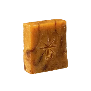 Black Altar Ritual Ember Bar — amber-hued soap marbled with deeper tones, embossed with the star-altar logo.