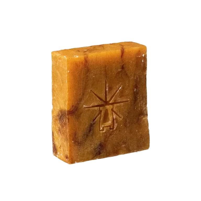Black Altar Ritual Ember Bar — amber-hued soap marbled with deeper tones, embossed with the star-altar logo.