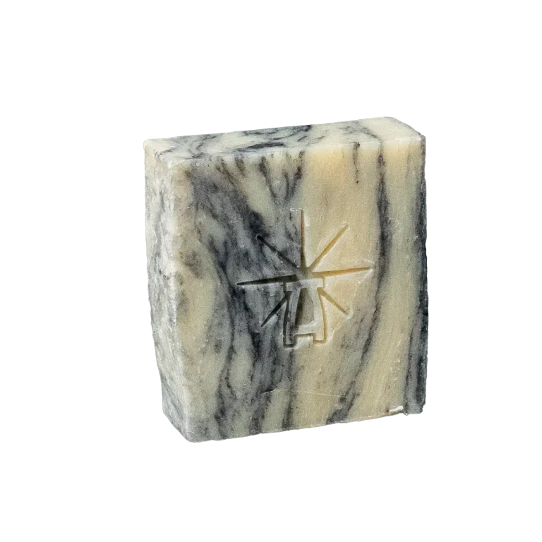 Black Altar Sacred Marble Bar — cream and charcoal swirled soap stamped with the star-altar logo. charcoal-clay-balance-cleansing-bar