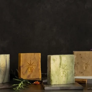 The altar's grace kit features each bar lined up in a dark moody scene surrounded by ingredients.