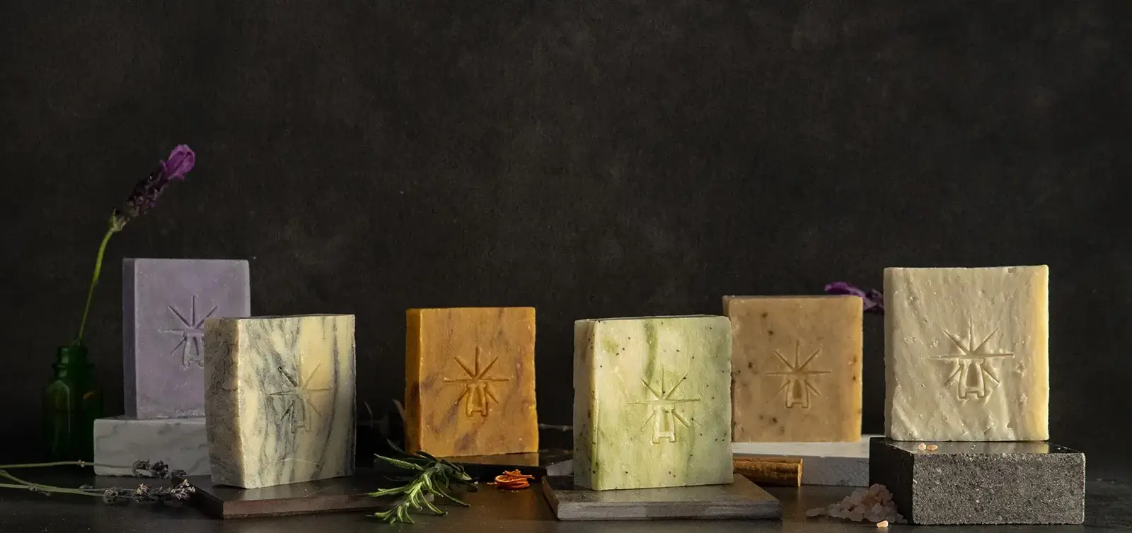 The altar's grace kit features each bar lined up in a dark moody scene surrounded by ingredients.