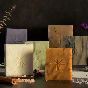 The altar's grace kit features each bar standing on mini altars closely in a dark moody scene surrounded by ingredients.