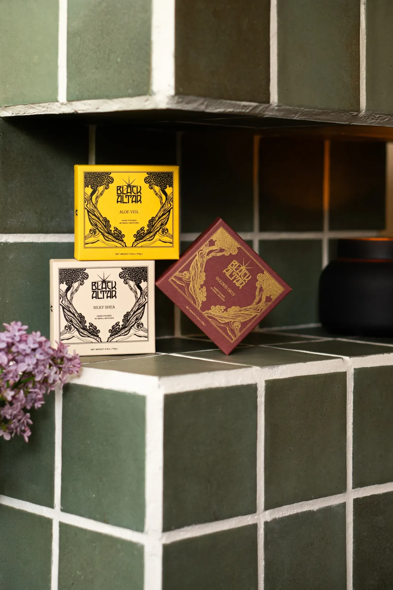 Black Altar boxed soap trio in yellow, cream, and mauve packaging on green tile