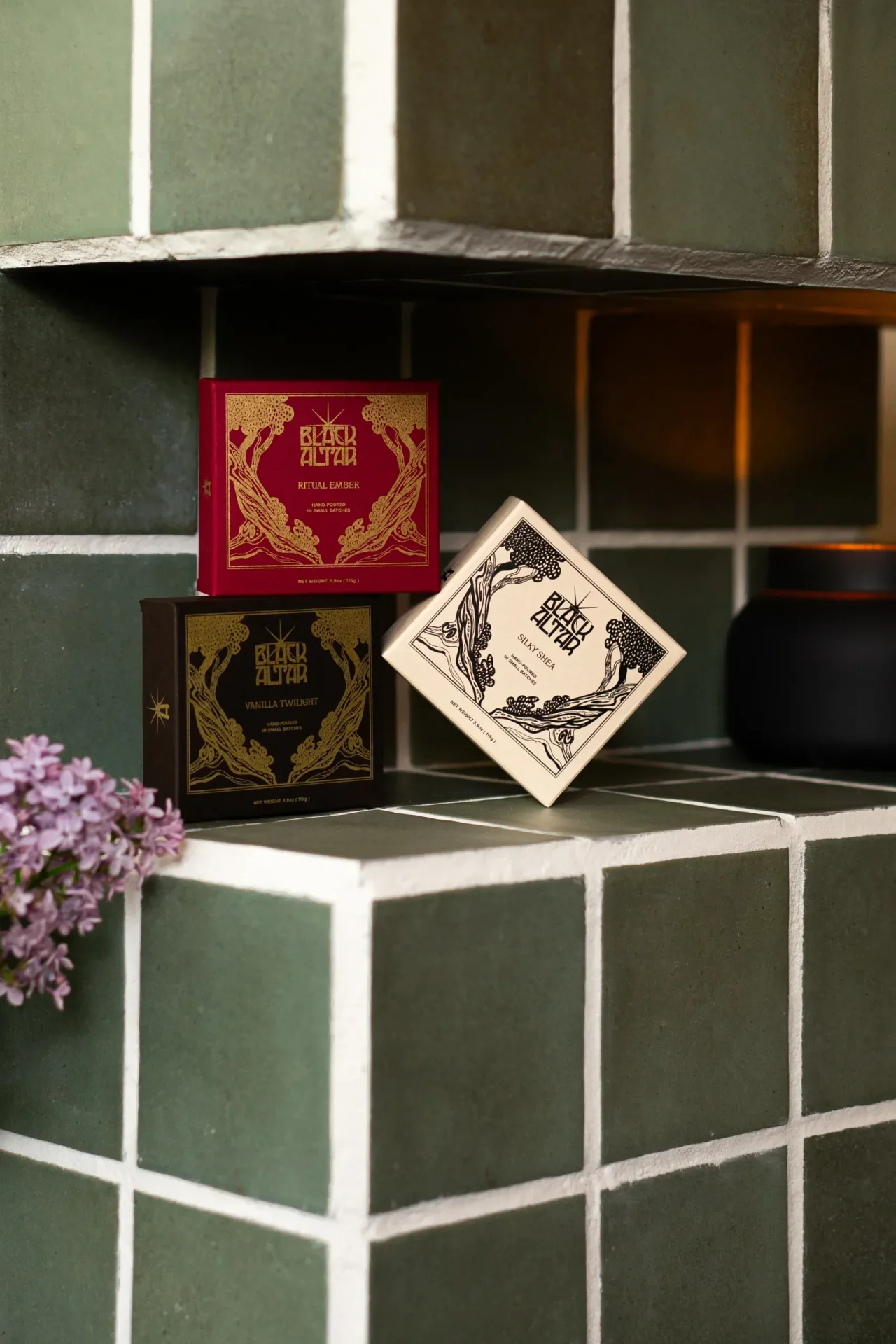 Stacked Black Altar soap boxes in red, cream, and black gold packaging