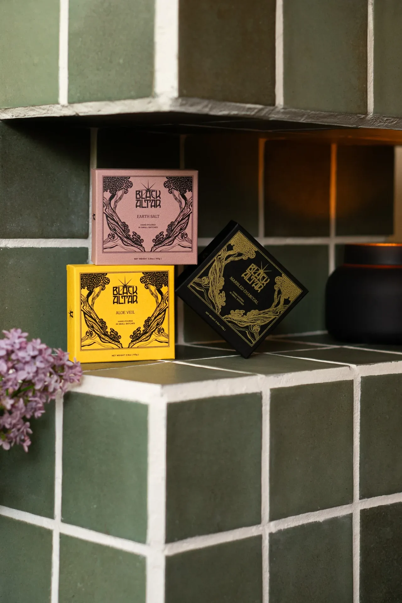 Stacked Black Altar soap boxes in pink, yellow, and black gold packaging