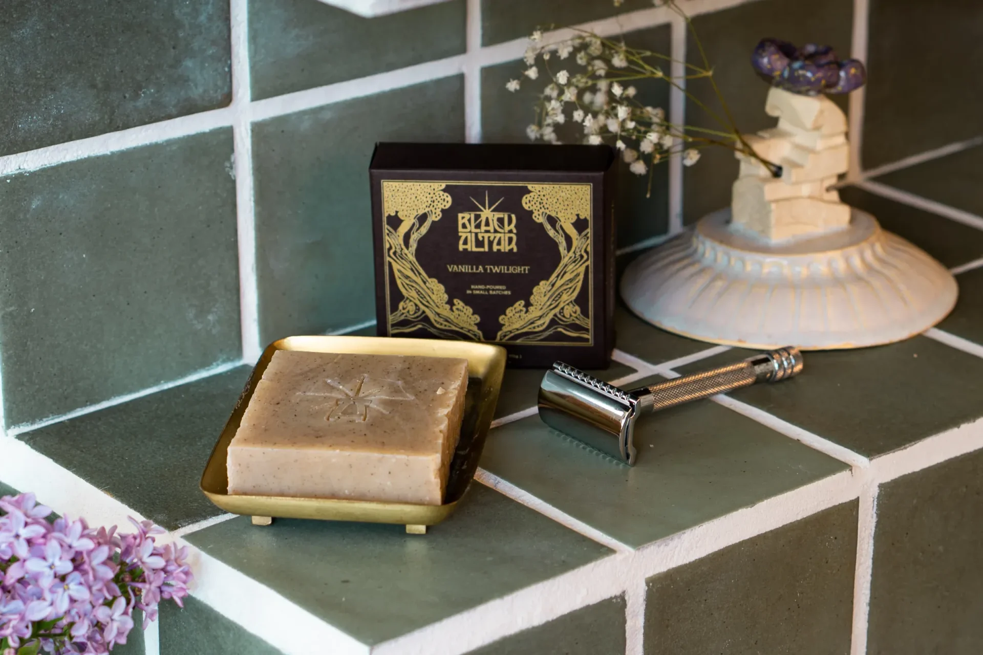 Black Altar black gold boxed soap with tan stamped bar on a brass tray
