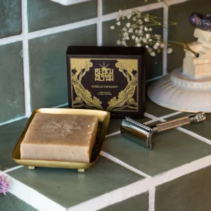 Black Altar black gold boxed soap with tan stamped bar on a brass tray